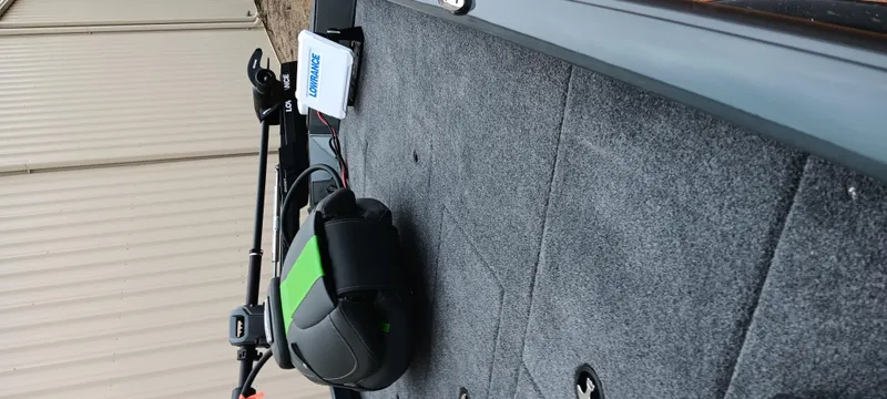 Slide: The Image of 2025 Ranger RT188C boat interior with carpeted deck and fishing equipment. - 15