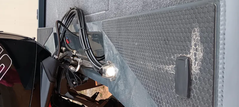 Slide: The Image of 2025 Ranger RT188C boat interior with cables and textured flooring. - 17