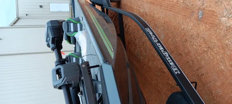 Slide: The Image of 2025 Ranger RT188C boat on trailer, parked on dirt near a building. - 4