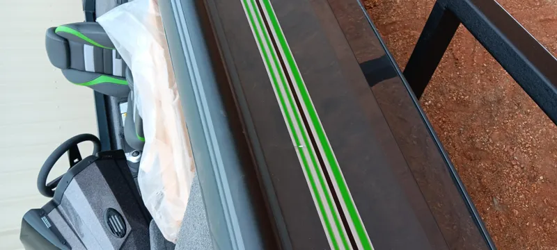 Slide: The Image of 2025 Ranger RT188C boat with green-striped design and dual seats, viewed from above. - 5