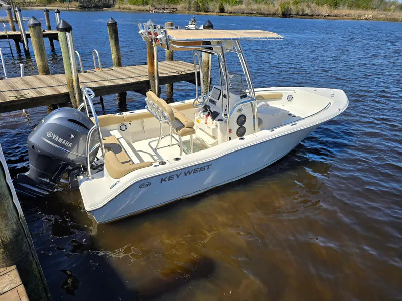 Slide: The Image of 2019 Key West 203 FS boat docked by a wooden pier on a sunny day. - 11