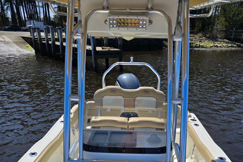 Slide: The Image of 2019 Key West 203 FS boat on water near dock, featuring seating and motor. - 13