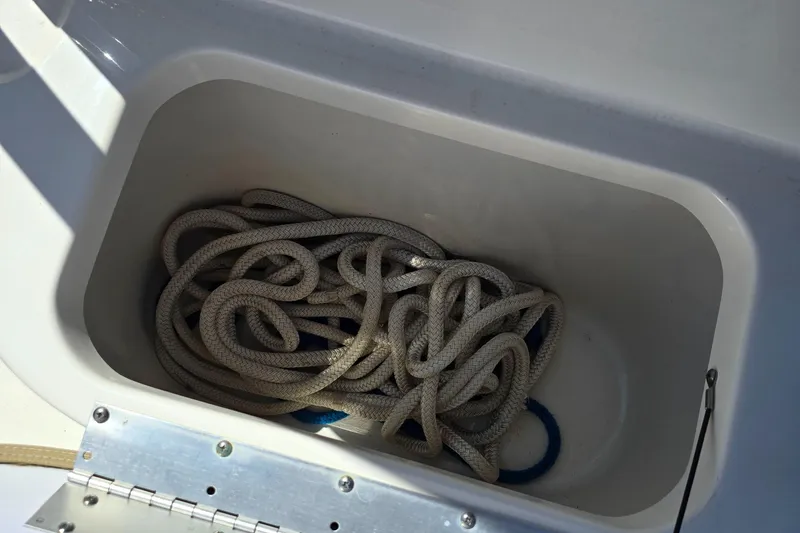 Slide: The Image of Rope stored in a compartment of a 2019 Key West 203 FS boat. - 19