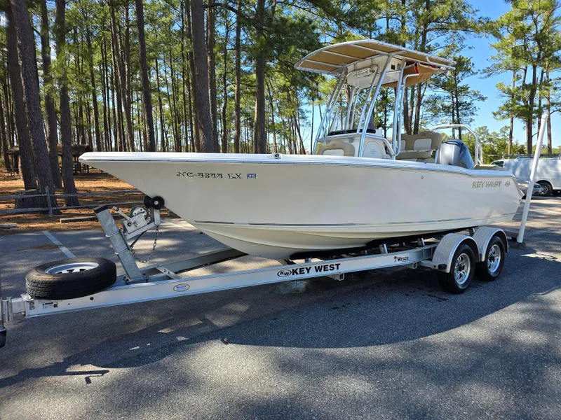 Slide: The Image of 2019 Key West 203 FS boat on trailer in wooded area. - 3
