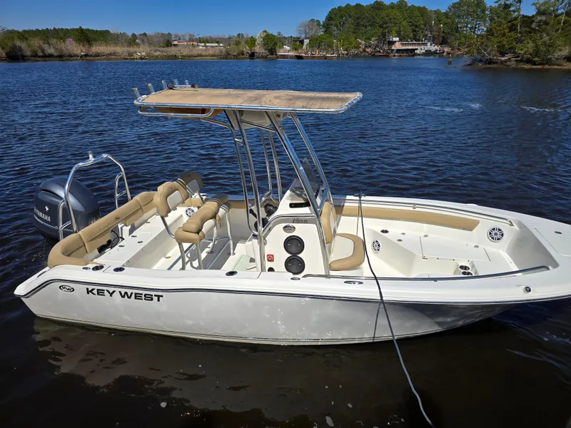 Slide: The Image of 2019 Key West 203 FS boat on calm lake with trees in background. - 4