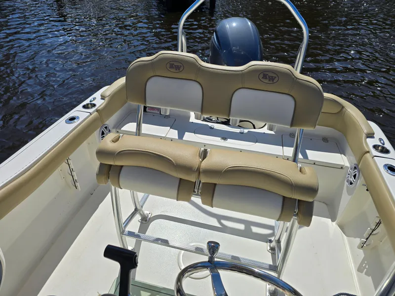 Slide: The Image of 2019 Key West 203 FS boat interior with beige seating and steering wheel. - 5