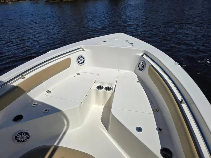 Slide: The Image of 2019 Key West 203 FS boat bow with seating and cup holders on calm water. - 8