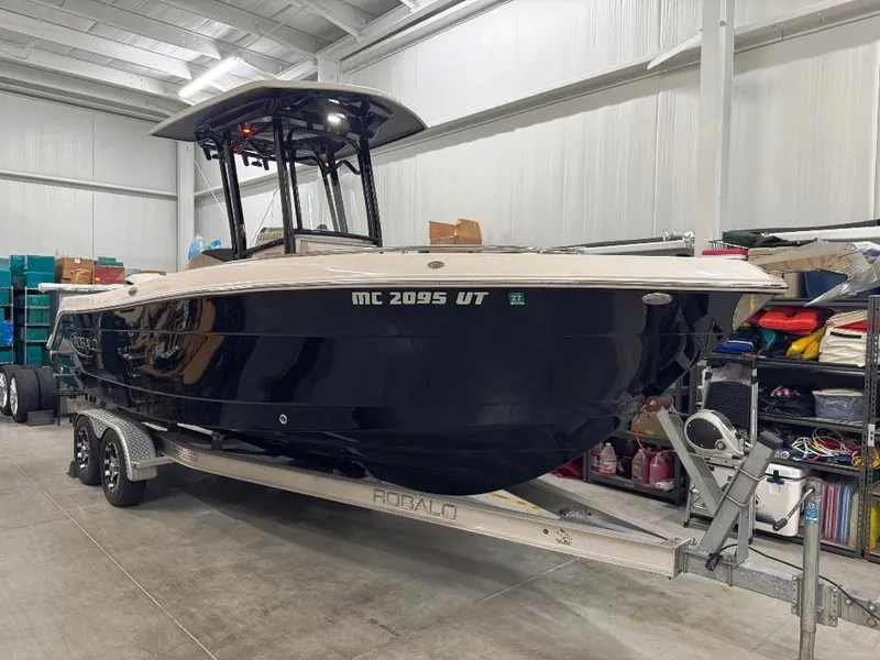 Slide: The Image of 2019 Robalo R242 Explorer boat on trailer in storage facility. - 1