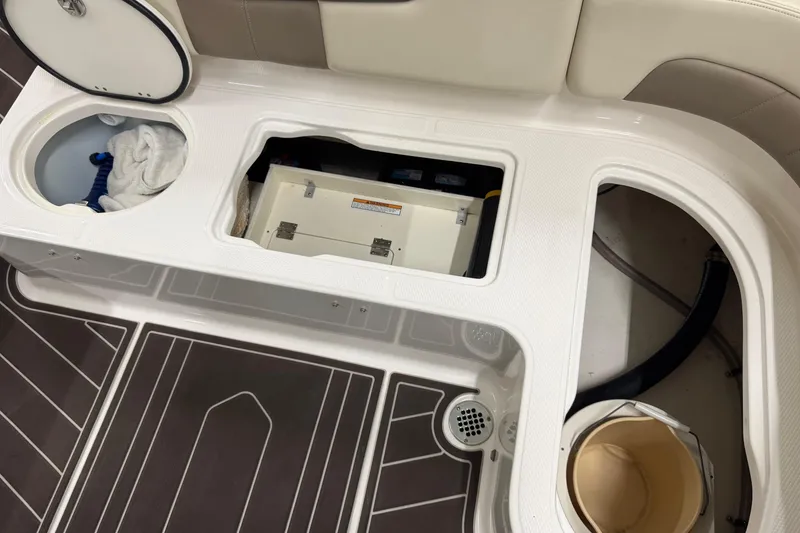 Slide: The Image of 2019 Robalo R242 Explorer boat storage compartments and seating area. - 10