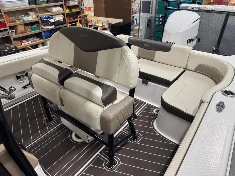Slide: The Image of 2019 Robalo R242 Explorer boat interior with beige and brown seating. - 11