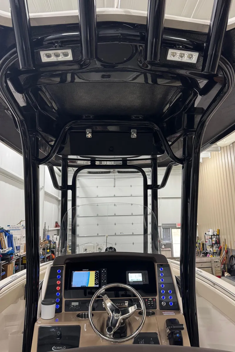 Slide: The Image of 2019 Robalo R242 Explorer boat console with navigation equipment and steering wheel. - 14