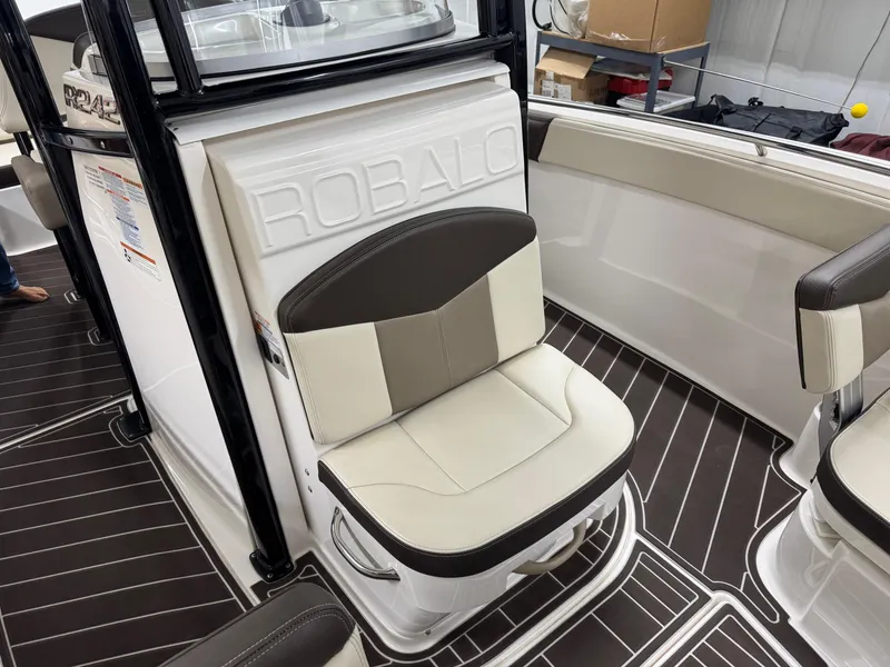 Slide: The Image of 2019 Robalo R242 Explorer boat interior with cushioned seating and sleek design. - 17