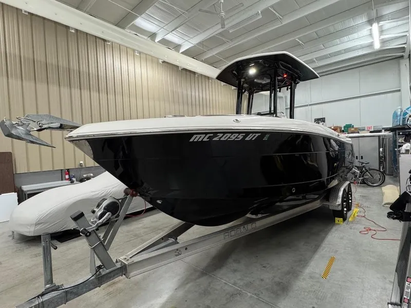 Slide: The Image of 2019 Robalo R242 Explorer boat on trailer in indoor storage facility. - 2