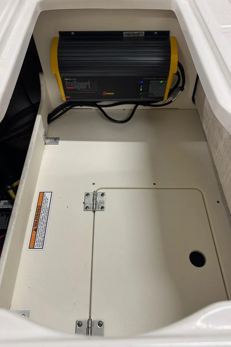 Slide: The Image of 2019 Robalo R242 Explorer storage compartment with battery charger. - 21