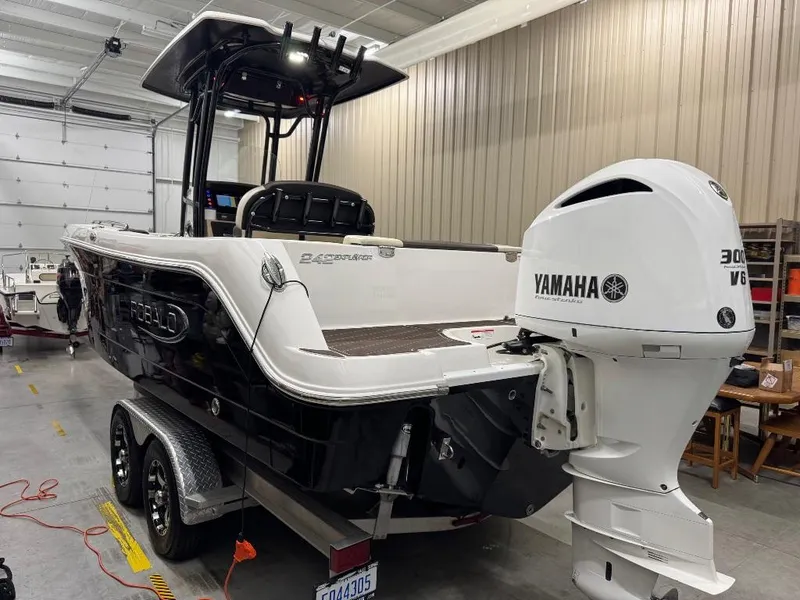 Slide: The Image of 2019 Robalo R242 Explorer boat with Yamaha 300 V6 engine in a garage. - 4