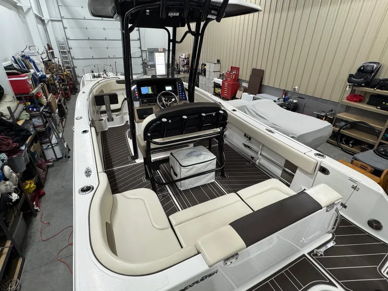 Slide: The Image of 2019 Robalo R242 Explorer boat interior in a garage setting. - 6