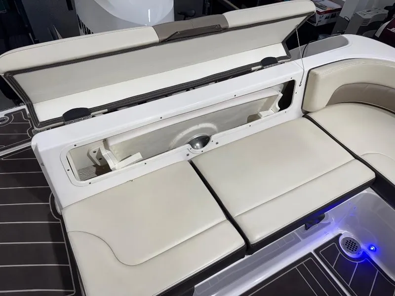 Slide: The Image of 2019 Robalo R242 Explorer boat with open storage compartment and cushioned seating. - 9