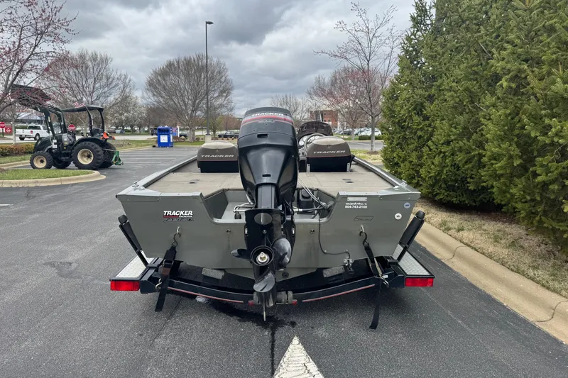 Slide: The Image of 2004 Tracker Tournament V-18 boat with outboard motor in parking lot. - 2
