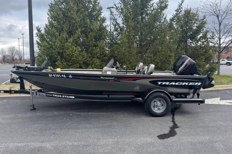 Slide: The Image of 2004 Tracker Tournament V-18 boat on trailer in parking lot. - 3