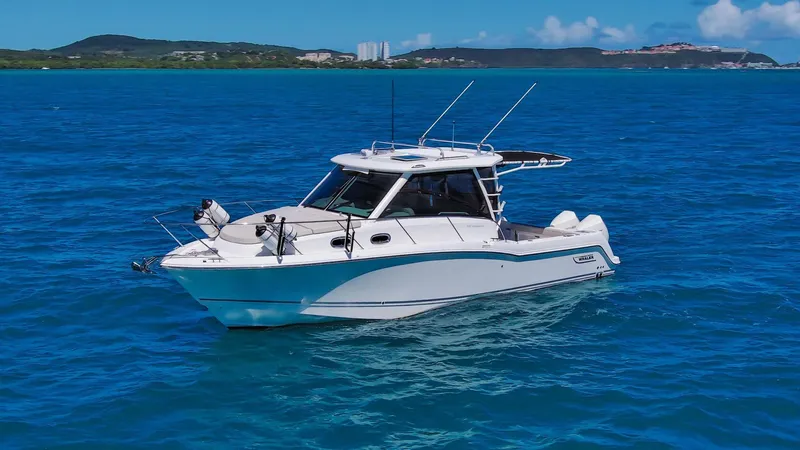 The Image of 2013 Boston Whaler 315 Conquest boat cruising on clear blue water. - 1