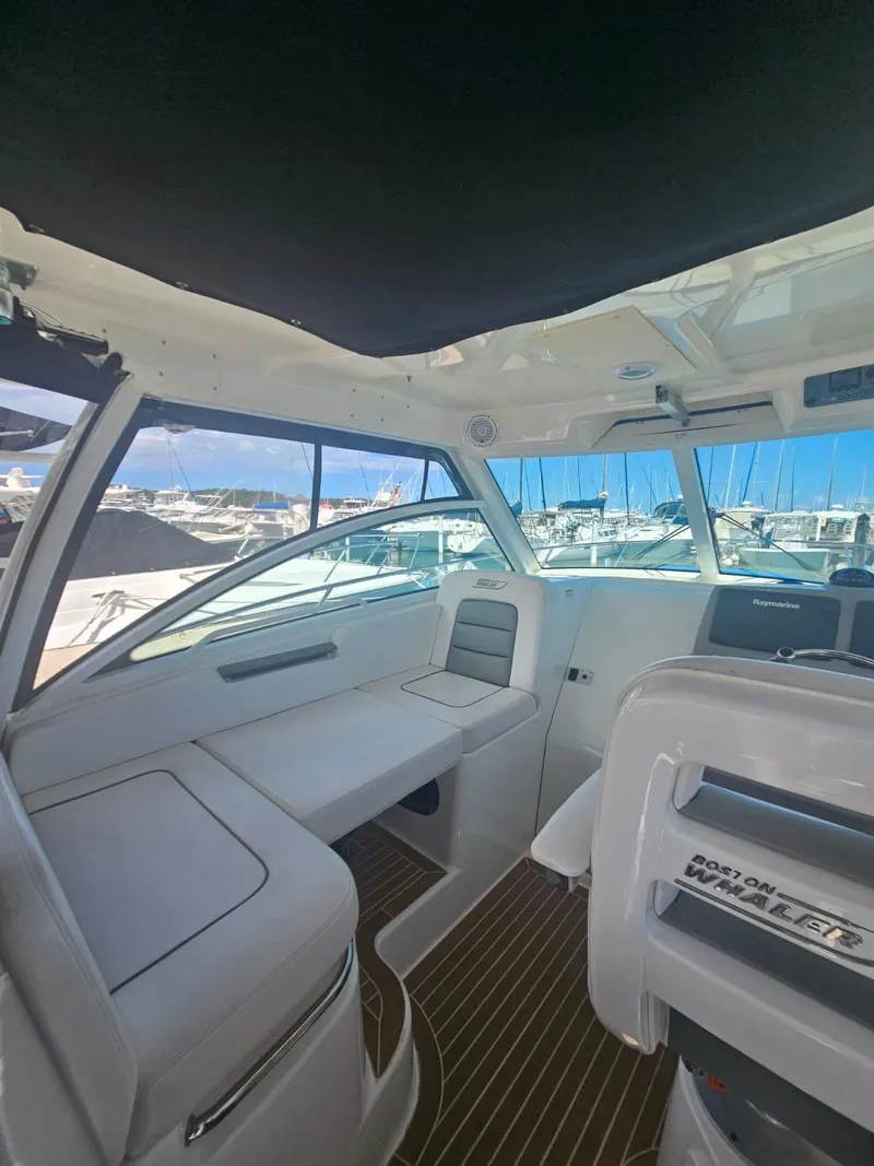Slide: The Image of Interior of a 2013 Boston Whaler 315 Conquest boat with seating and helm. - 13