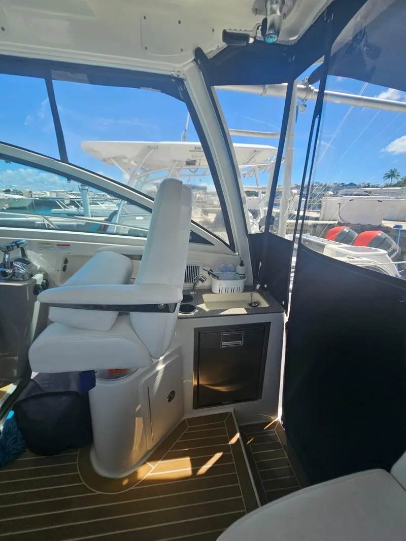 Slide: The Image of Interior view of 2013 Boston Whaler 315 Conquest boat with helm and seating area. - 18