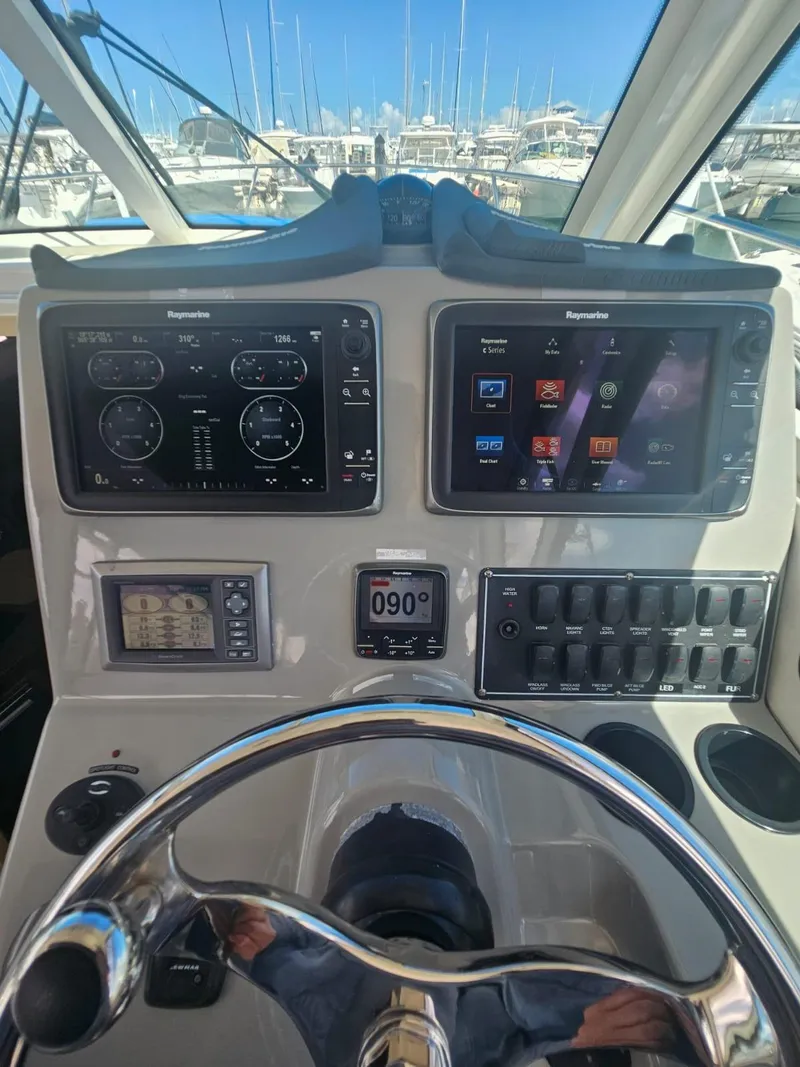 Slide: The Image of Control panel of 2013 Boston Whaler 315 Conquest with navigation screens and steering wheel. - 20