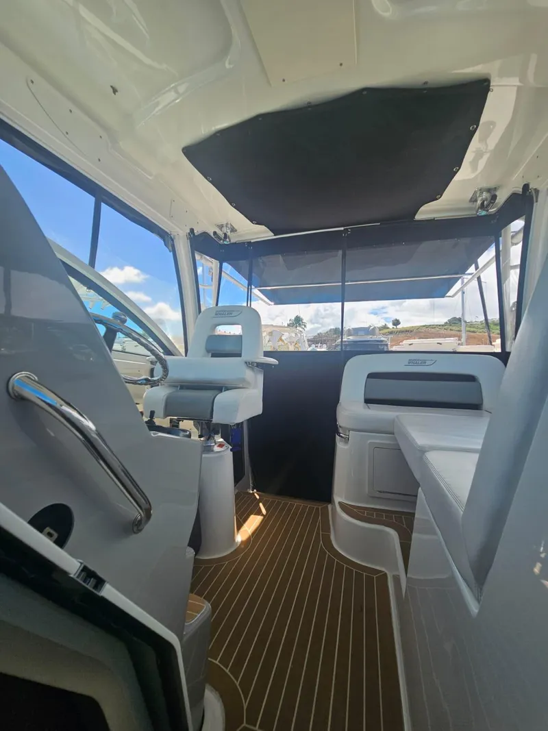 Slide: The Image of Interior view of 2013 Boston Whaler 315 Conquest boat with seating and helm. - 5