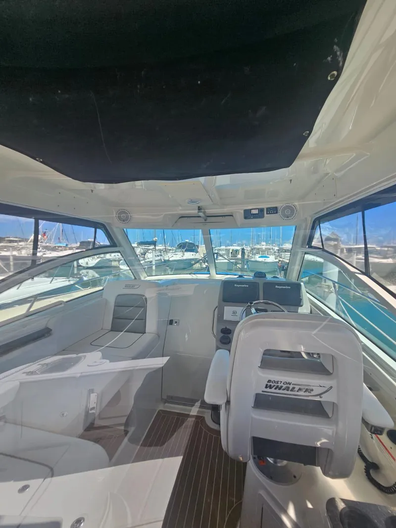 Slide: The Image of Interior view of 2013 Boston Whaler 315 Conquest boat with helm and seating. - 9