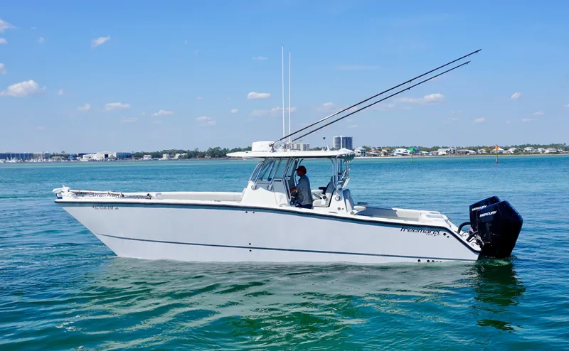 Slide: The Image of 2020 Freeman VH boat on calm water, clear sky, distant shoreline. - 1