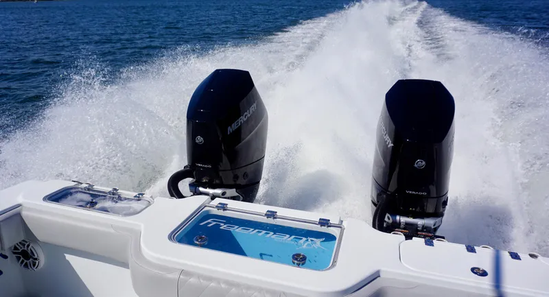 Slide: The Image of Freeman VH 2020 boat with dual Mercury outboard engines cruising on open water. - 11