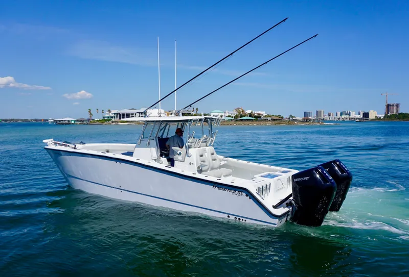 Slide: The Image of 2020 Freeman VH boat cruising on clear blue water with twin Mercury engines. - 3