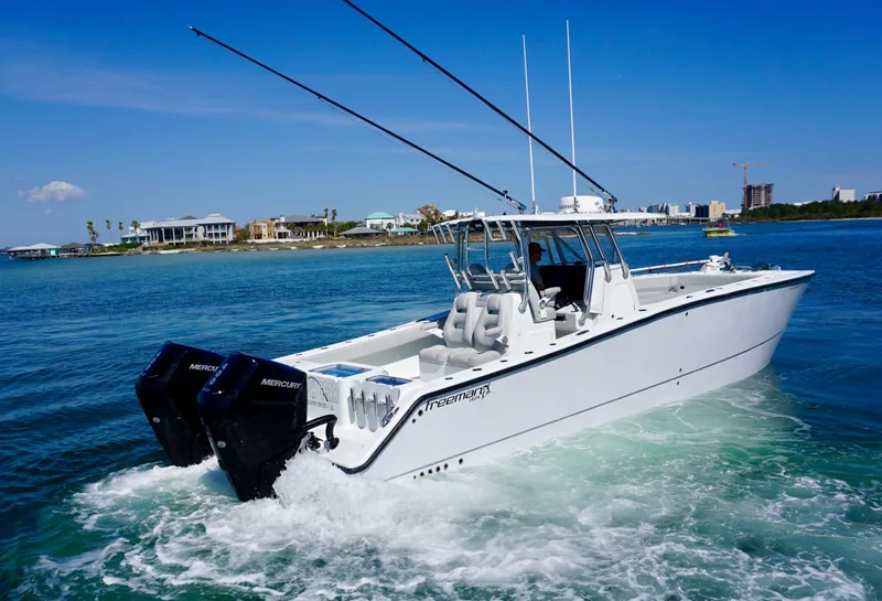 Slide: The Image of Freeman VH 2020 boat cruising on clear blue water near a coastal area. - 4