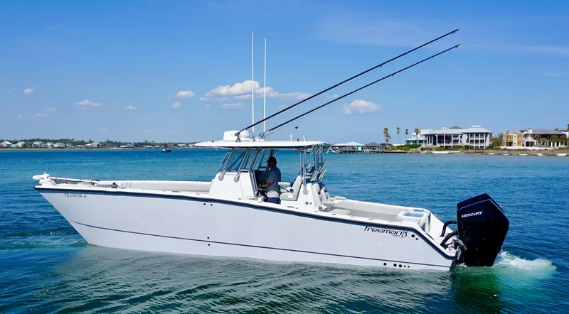 Slide: The Image of Freeman VH 2020 boat cruising on clear blue water near coastal homes. - 5