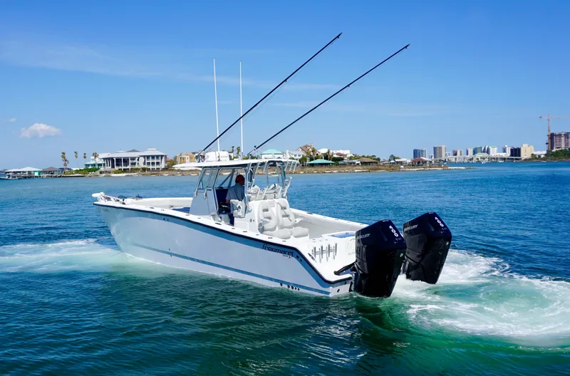 Slide: The Image of 2020 Freeman VH boat cruising on clear blue water near a coastal city. - 6