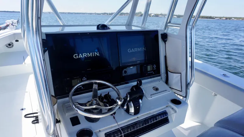 Slide: The Image of Freeman VH 2020 boat dashboard with Garmin navigation screens on open water. - 9