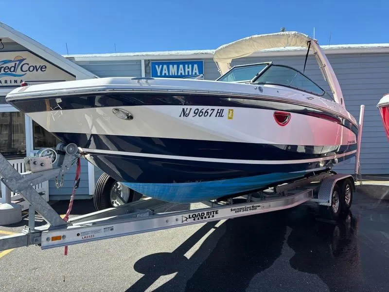 Slide: The Image of 2018 Regal 26 OBX boat on trailer, displayed outside a Yamaha dealership. - 1