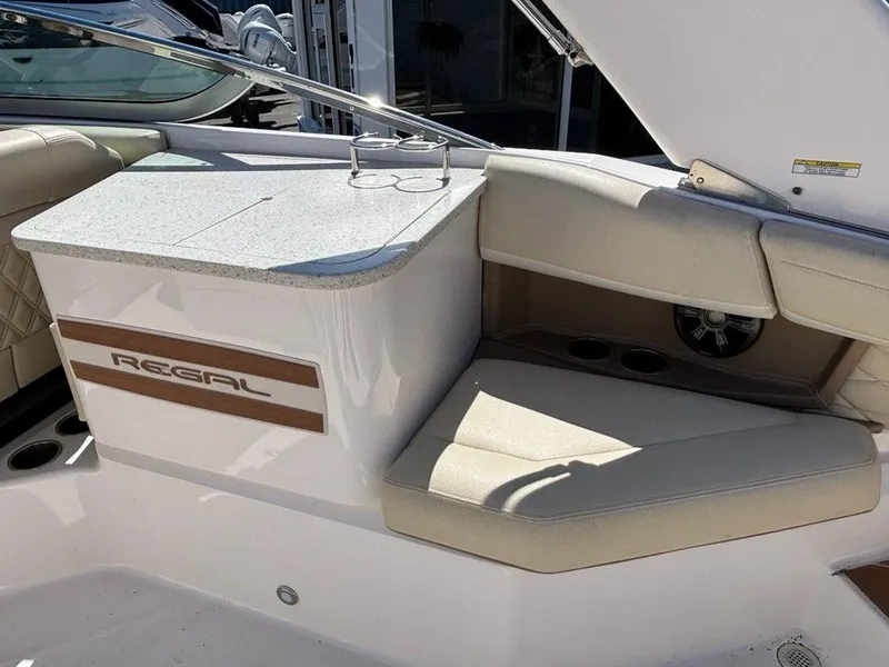 Slide: The Image of 2018 Regal 26 OBX boat interior with beige seating and countertop. - 10