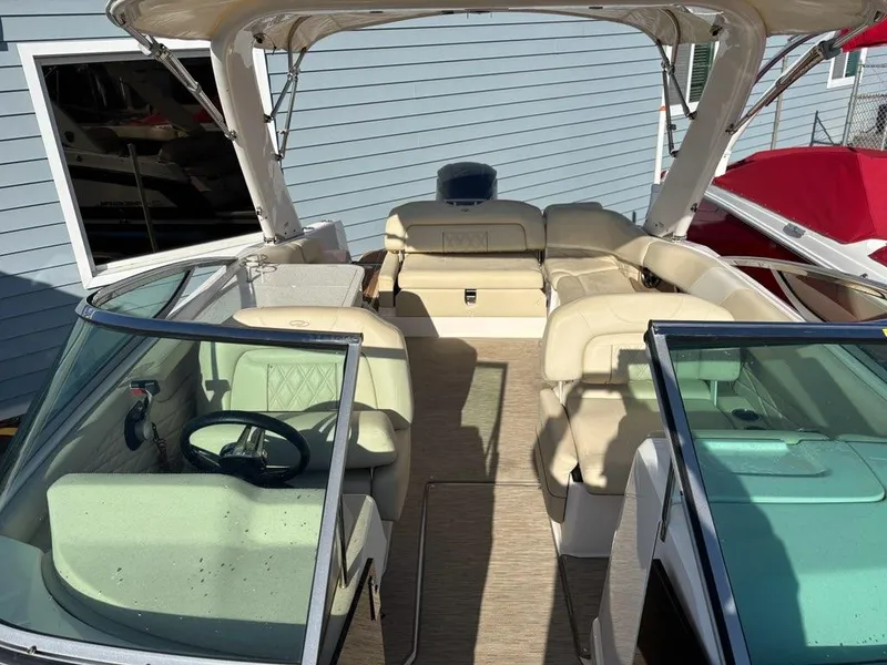 Slide: The Image of 2018 Regal 26 OBX boat interior with beige seating and dual windshields. - 15
