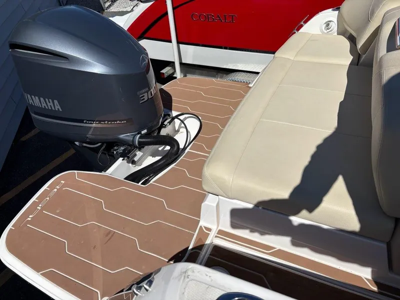 Slide: The Image of 2018 Regal 26 OBX boat with Yamaha 300 engine and beige seating. - 4