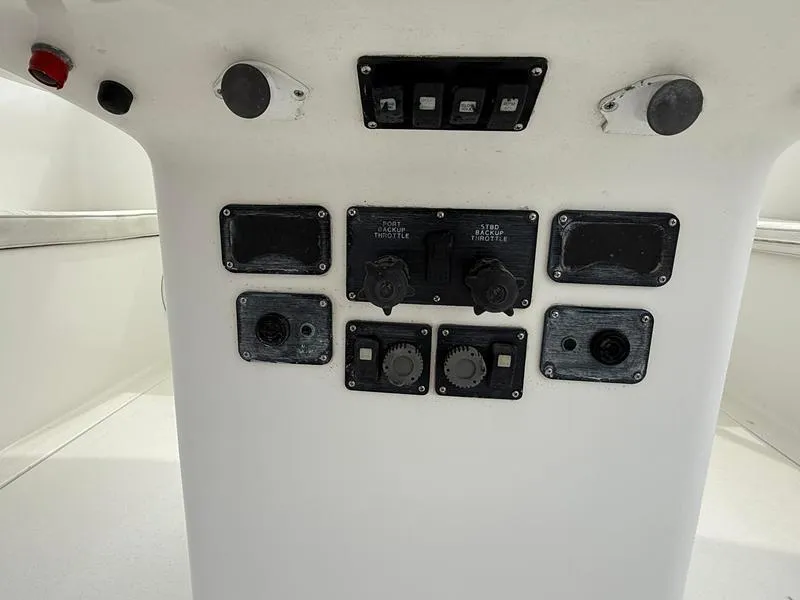 Slide: The Image of Control panel of 2005 Out Island 38 Express Fisherman boat, featuring various switches and dials. - 10