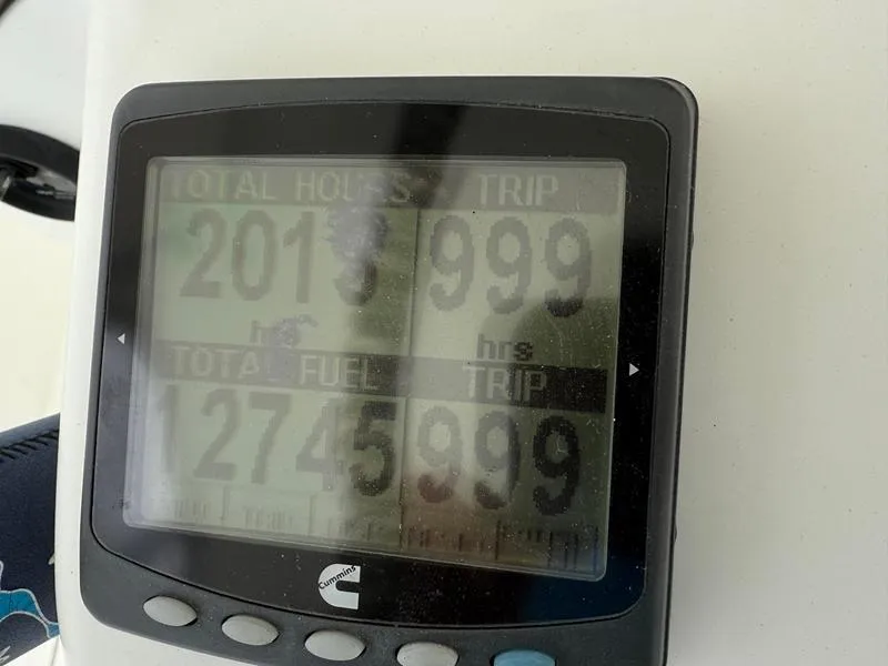 Slide: The Image of Display screen showing total hours and fuel usage on a 2005 Out Island 38 Express Fisherman. - 18