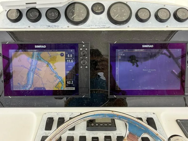 Slide: The Image of 2005 Out Island 38 Express Fisherman dashboard with Simrad navigation displays and gauges. - 22