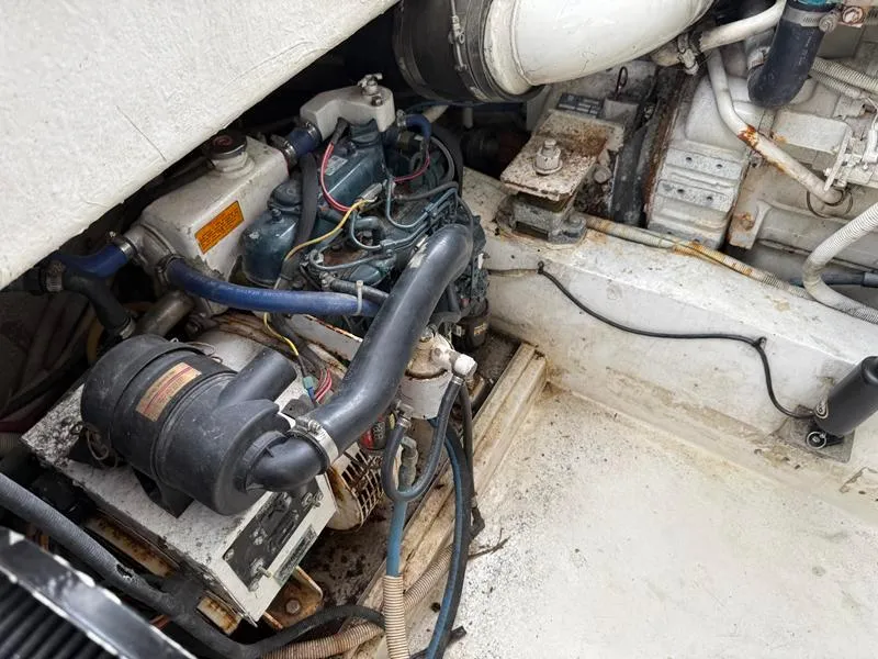 Slide: The Image of Engine compartment of a 2005 Out Island 38 Express Fisherman boat, showing mechanical components. - 26