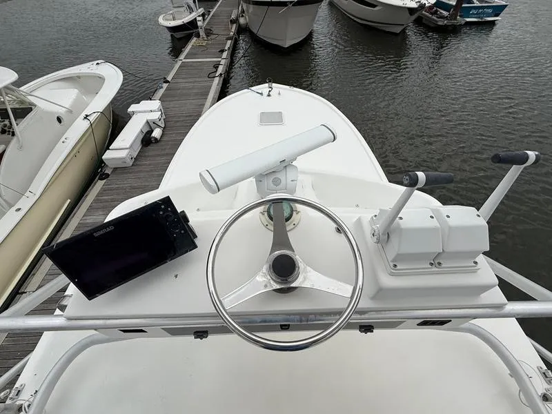 Slide: The Image of 2005 Out Island 38 Express Fisherman boat helm with steering wheel and navigation equipment. - 27