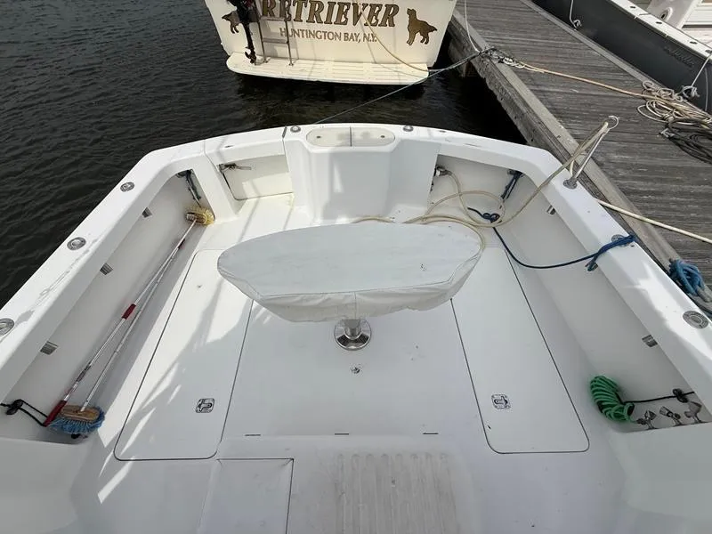 Slide: The Image of 2005 Out Island 38 Express Fisherman boat deck, docked, with fishing equipment and clean white surface. - 3