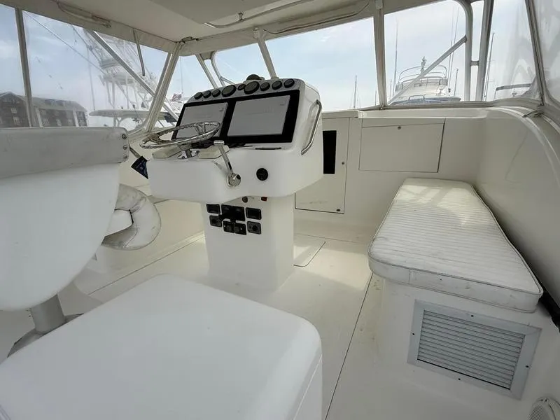 Slide: The Image of 2005 Out Island 38 Express Fisherman boat interior with helm, seating, and navigation controls. - 7