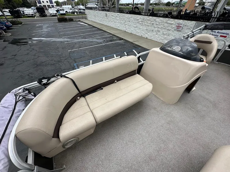 Slide: The Image of 2019 Sun Tracker Party Barge 18 DLX with beige seating in a parking lot. - 13