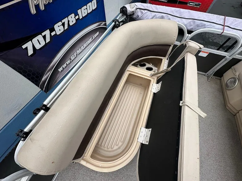 Slide: The Image of 2019 Sun Tracker Party Barge 18 DLX seating with storage compartment open. - 15