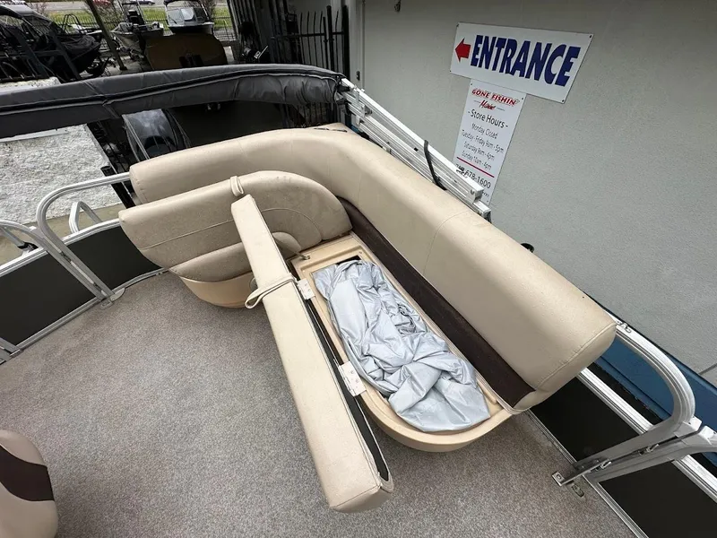 Slide: The Image of 2019 Sun Tracker Party Barge 18 DLX pontoon boat with beige seating and storage compartment. - 17